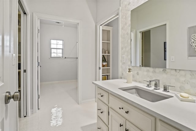 bathroom featuring vanity, backsplash, and tile patterned floors