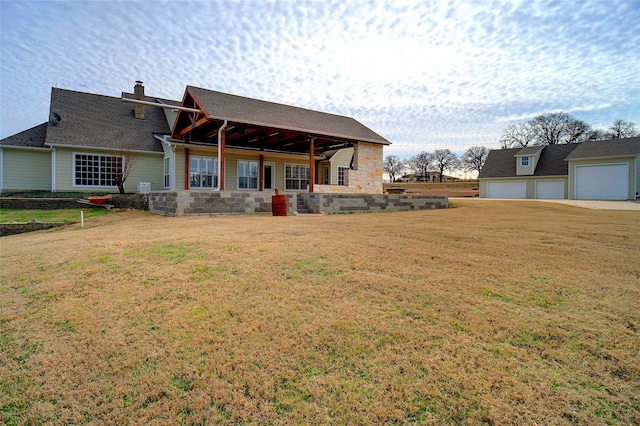 back of house with a patio area, a garage, a lawn, and ceiling fan