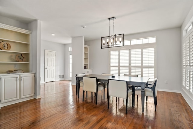 dining room with a notable chandelier, hardwood / wood-style floors, and a wealth of natural light