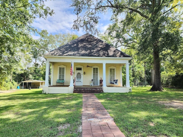 bungalow with covered porch and a front yard