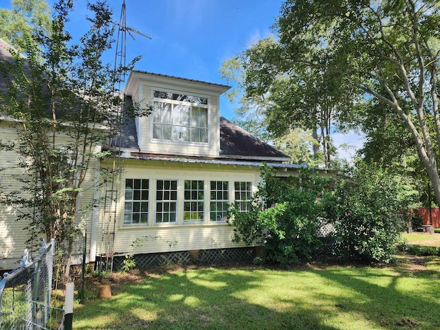 view of home's exterior featuring a lawn