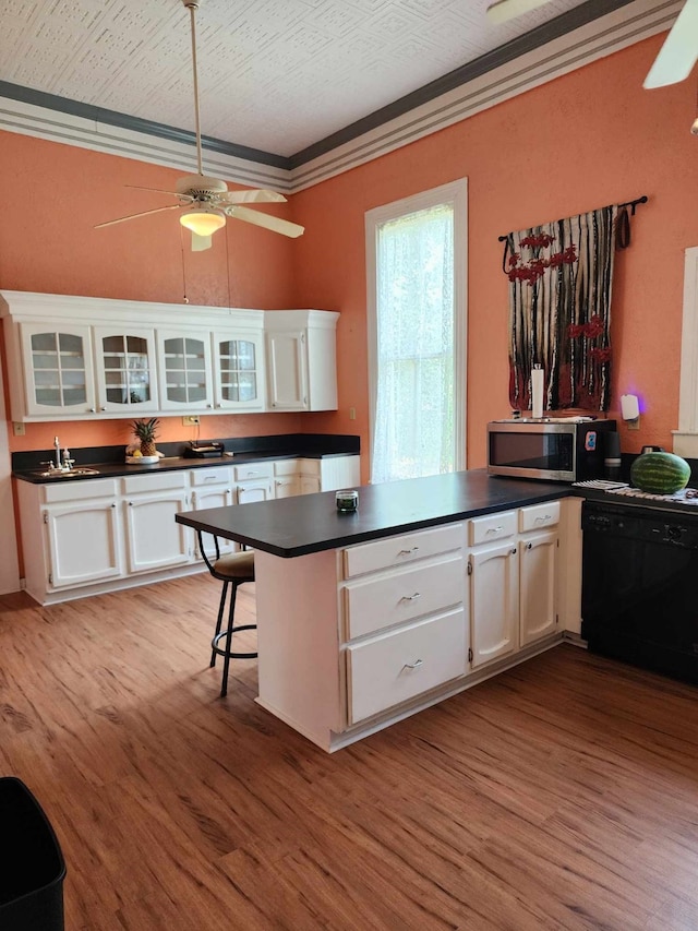 kitchen with crown molding, dishwasher, light hardwood / wood-style floors, and white cabinets