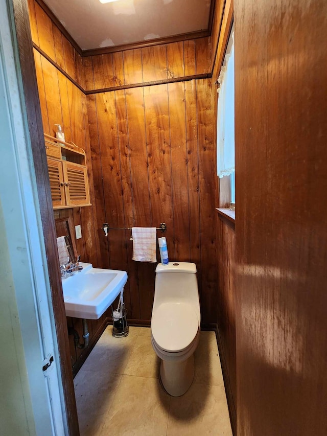 bathroom featuring toilet and wood walls