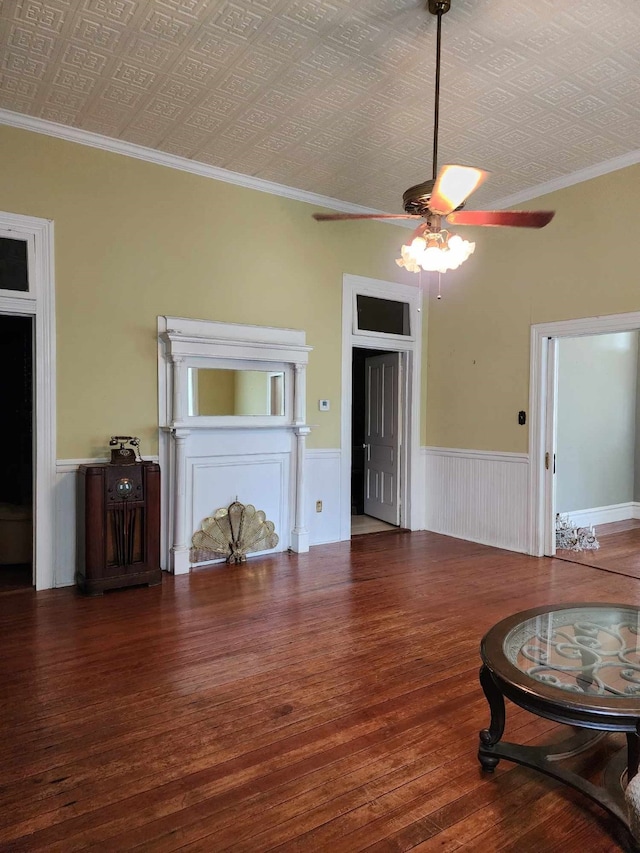 living room with crown molding, ceiling fan, and dark hardwood / wood-style flooring