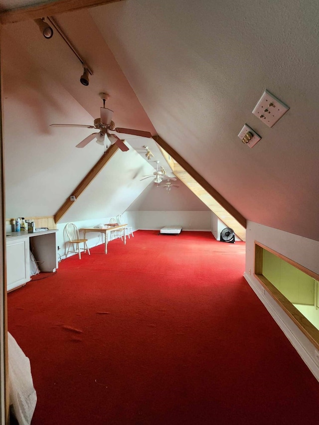 bonus room with lofted ceiling, carpet flooring, and ceiling fan