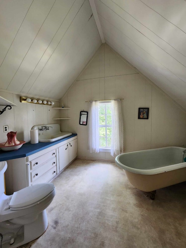 bathroom with vanity, a tub, toilet, and lofted ceiling