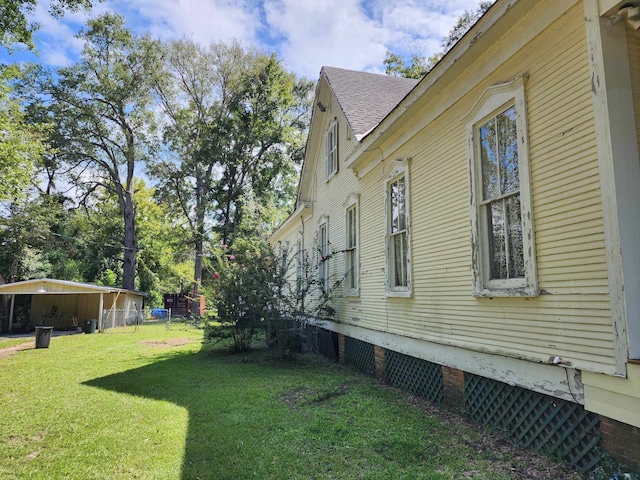 view of side of property with a storage shed and a lawn