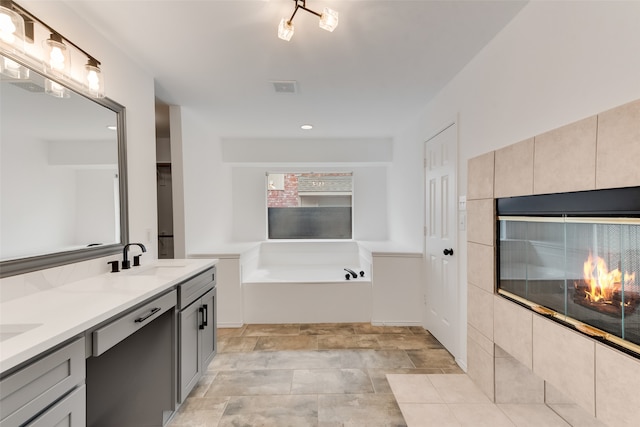 bathroom with vanity and a tub