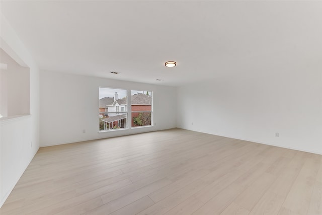 spare room featuring light hardwood / wood-style floors