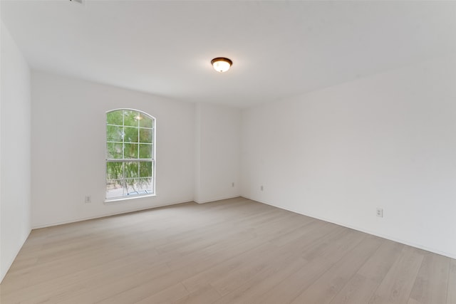 empty room with light hardwood / wood-style flooring