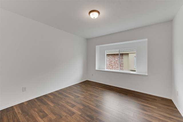 empty room featuring dark wood-type flooring