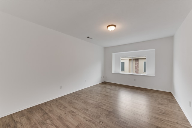 empty room with wood-type flooring