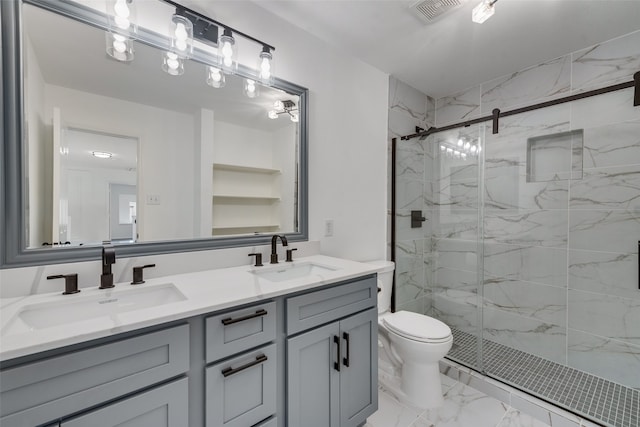 bathroom with toilet, vanity, and a shower with door