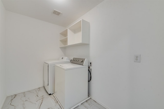 laundry room with washing machine and clothes dryer