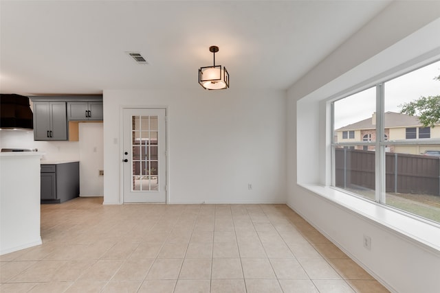 unfurnished dining area with light tile patterned floors