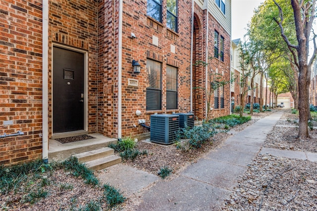 doorway to property featuring central air condition unit