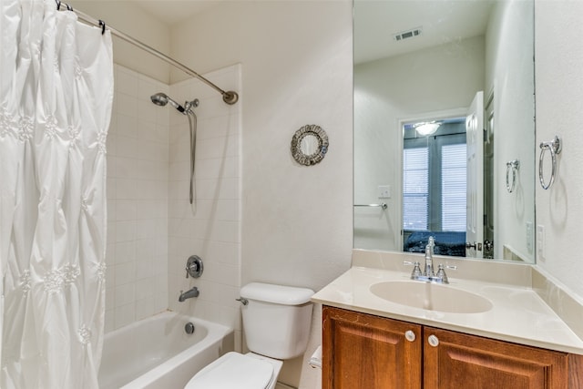 full bathroom featuring vanity, shower / tub combo with curtain, and toilet