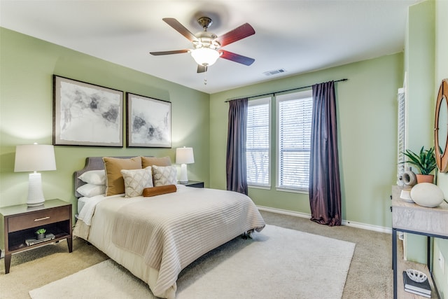 bedroom featuring light colored carpet and ceiling fan