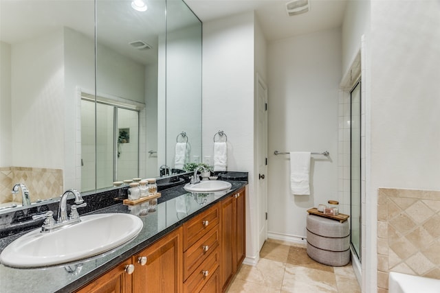 bathroom with vanity, tile patterned flooring, and an enclosed shower