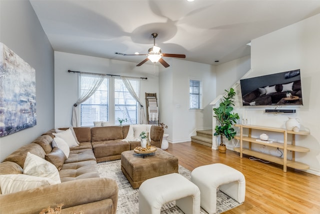 living room featuring hardwood / wood-style floors and ceiling fan