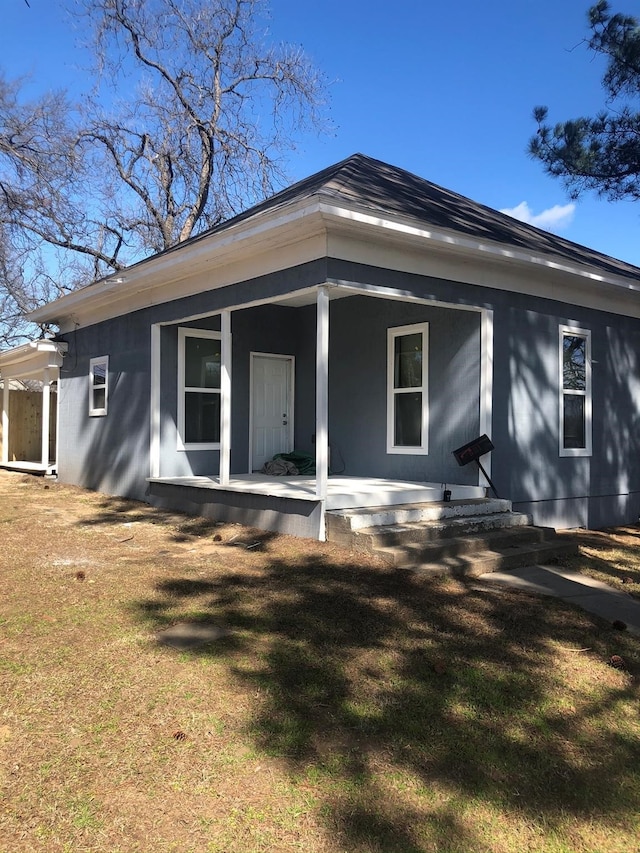 back of property featuring a yard