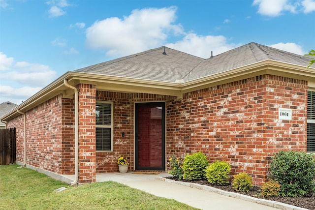 doorway to property with a lawn