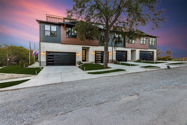 contemporary house featuring a yard and a garage