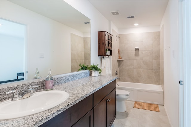 full bathroom featuring toilet, tile patterned flooring, vanity, and tiled shower / bath combo