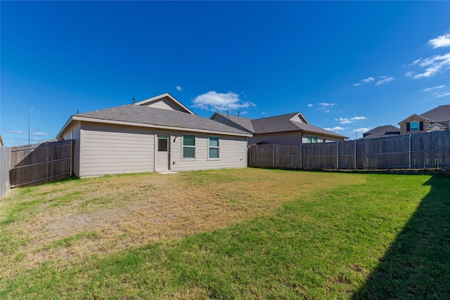 rear view of house with a yard