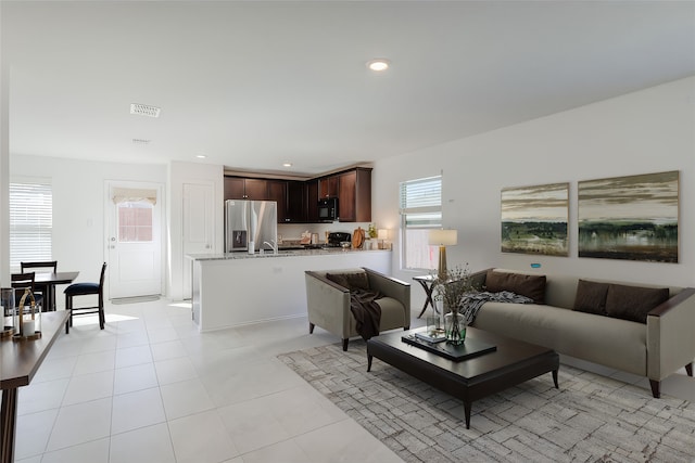 living room with sink and light tile patterned floors