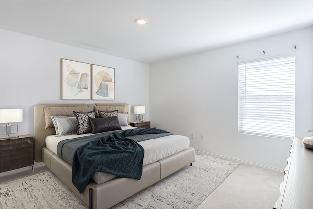 carpeted bedroom featuring multiple windows