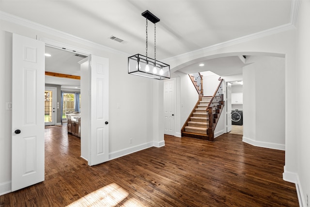 unfurnished dining area with dark hardwood / wood-style flooring, washer / clothes dryer, and crown molding