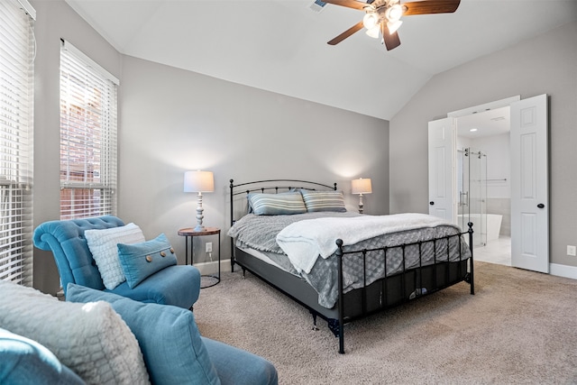 bedroom with vaulted ceiling, ceiling fan, connected bathroom, and carpet floors