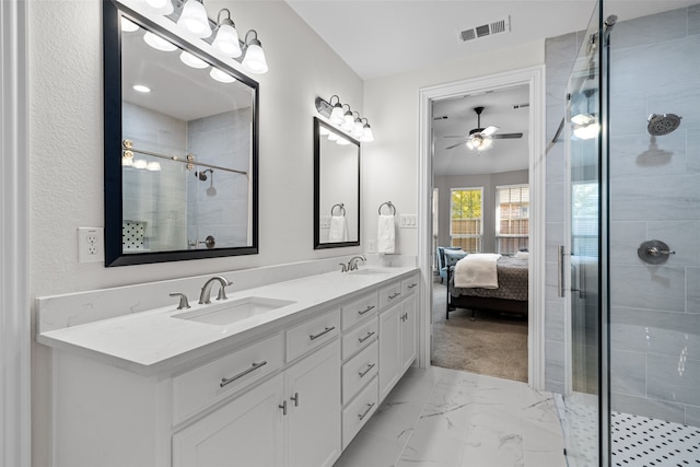 bathroom featuring vanity, an enclosed shower, and ceiling fan