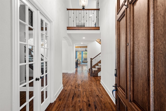 kitchen with white cabinetry, appliances with stainless steel finishes, hanging light fixtures, light hardwood / wood-style flooring, and a large island