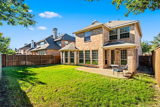 back of property featuring a patio and a yard