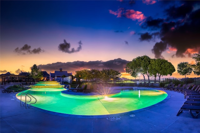 pool at dusk with a patio