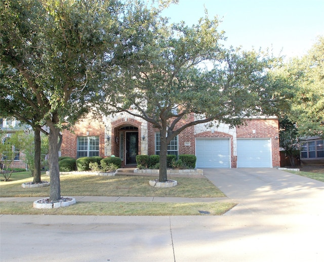 view of front facade featuring a front yard and a garage