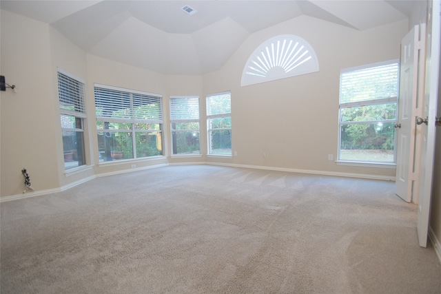 carpeted empty room with lofted ceiling