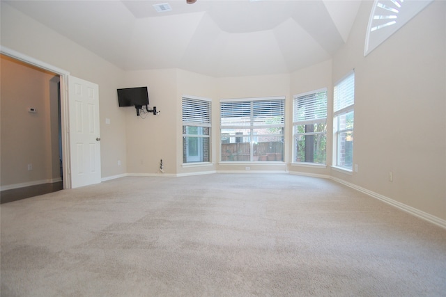 spare room featuring vaulted ceiling and carpet flooring