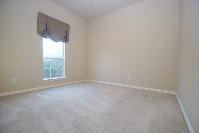 spare room with light colored carpet