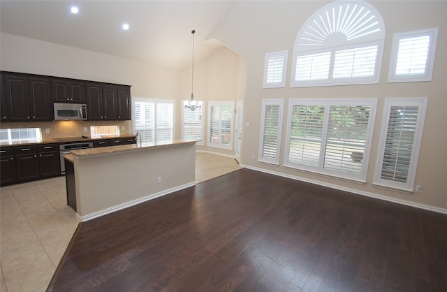 kitchen featuring pendant lighting, appliances with stainless steel finishes, light hardwood / wood-style flooring, and plenty of natural light