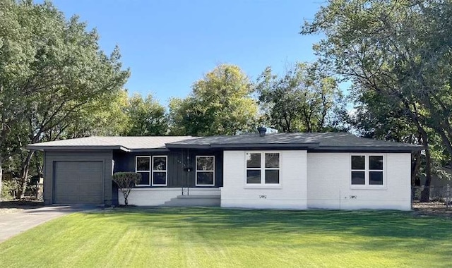 single story home featuring a front yard and a garage