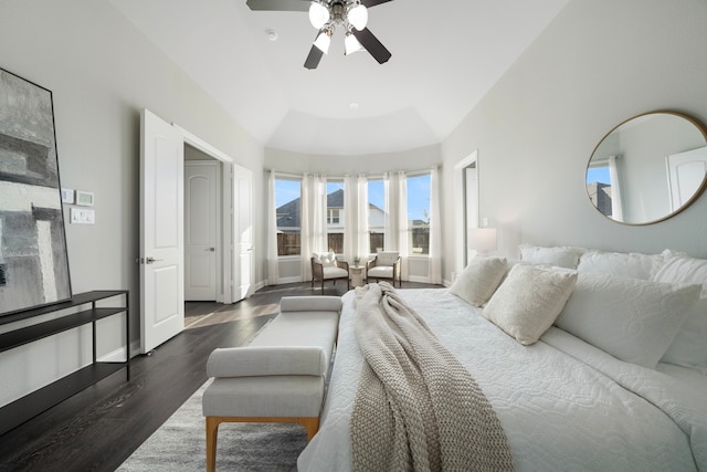 bedroom featuring ceiling fan, dark hardwood / wood-style floors, and vaulted ceiling