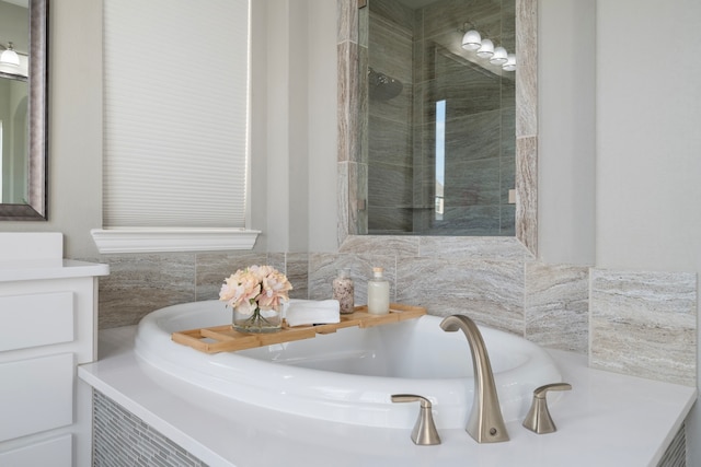 bathroom featuring vanity and separate shower and tub