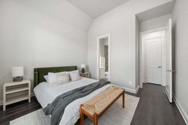 bedroom featuring vaulted ceiling, dark hardwood / wood-style flooring, and ensuite bathroom