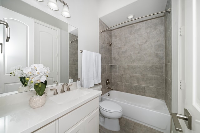 full bathroom with tile patterned flooring, vanity, toilet, and tiled shower / bath combo