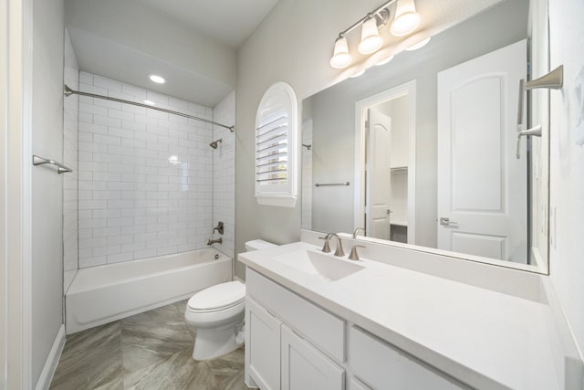 full bathroom with vanity, toilet, and tiled shower / bath combo