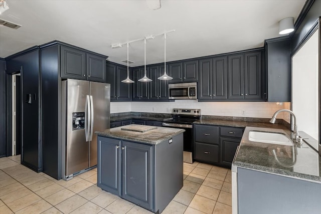 kitchen featuring appliances with stainless steel finishes, sink, a center island, decorative light fixtures, and light tile patterned floors