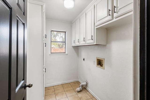 washroom with hookup for a washing machine, light tile patterned floors, crown molding, electric dryer hookup, and cabinets